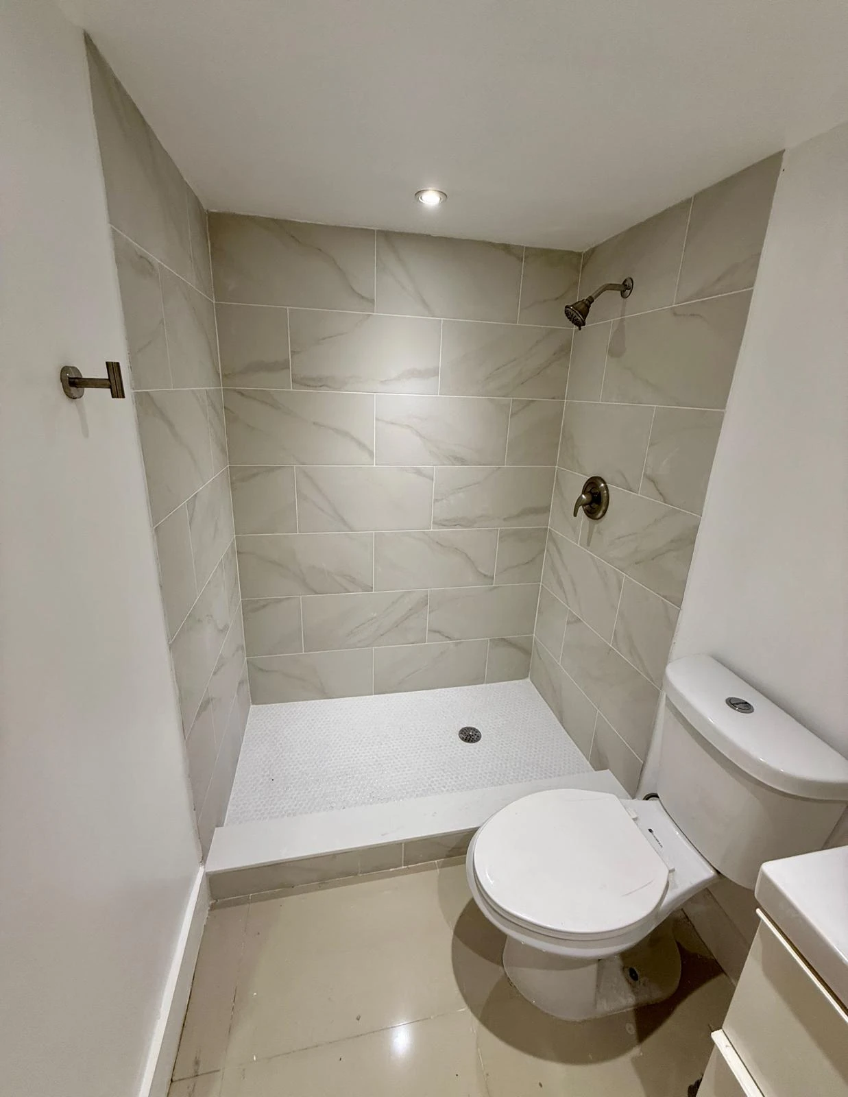 Custom marble walk-in shower by Patagonia Construction in Aventura, Miami