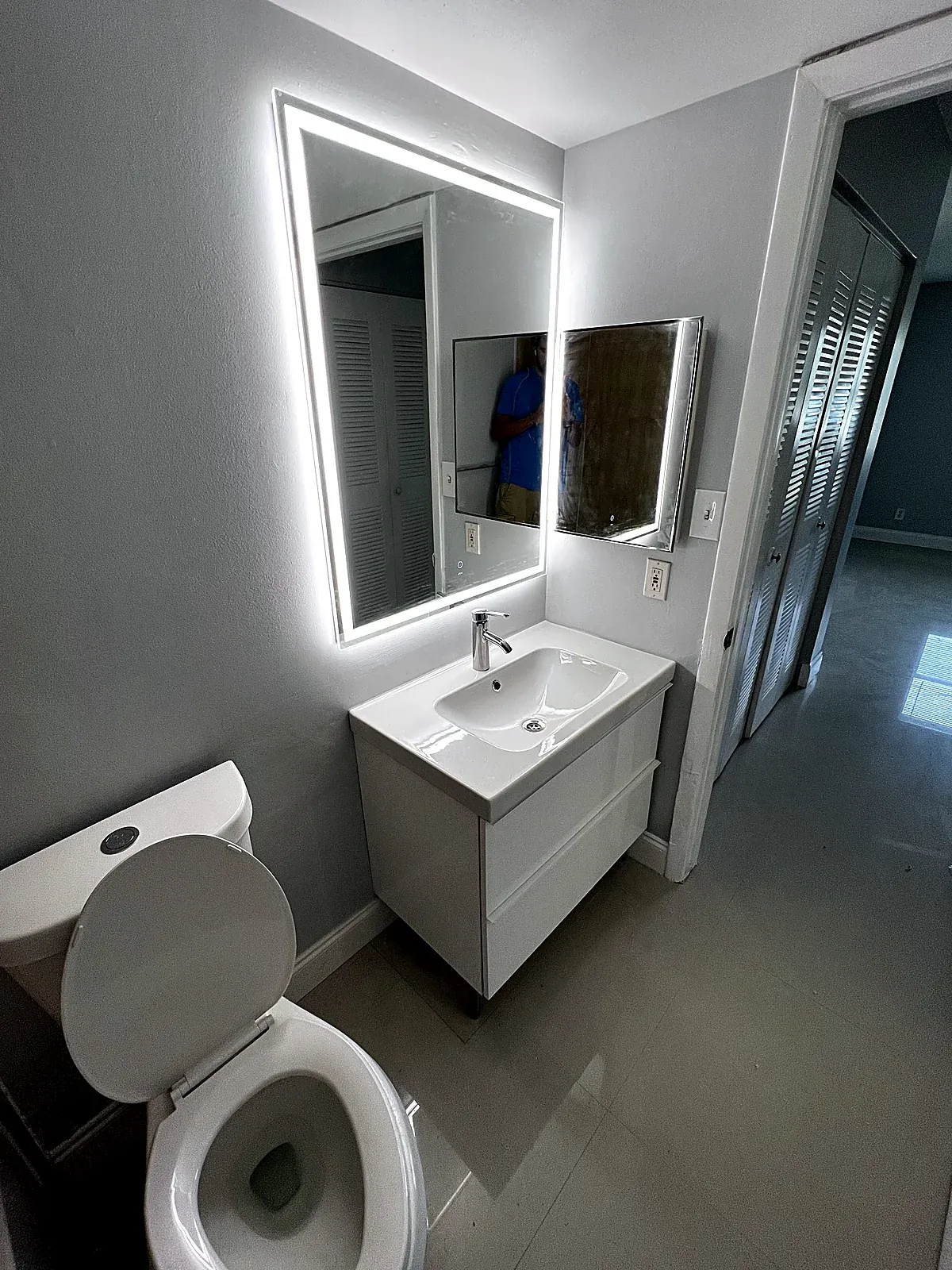 Bathroom after the refresh with a new vanity, LED mirror, floor tile and fresh paint in Hollywood