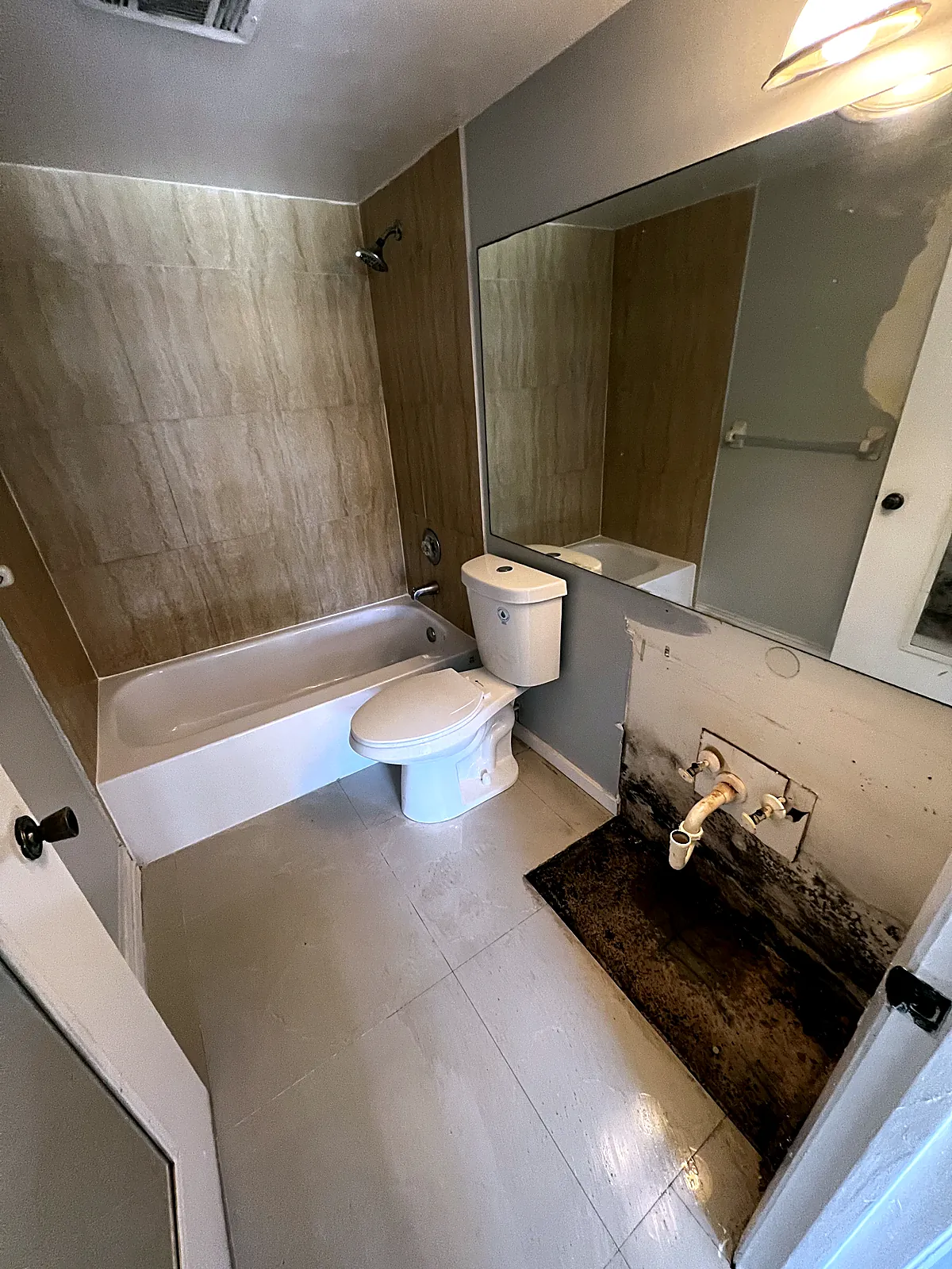 Second bathroom before the refresh, with dated tile surround and the vanity removed in Hollywood