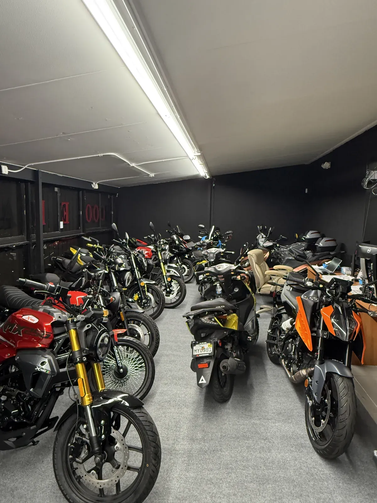 Motorcycle showroom with painted walls and high-traffic floor coating in Miami