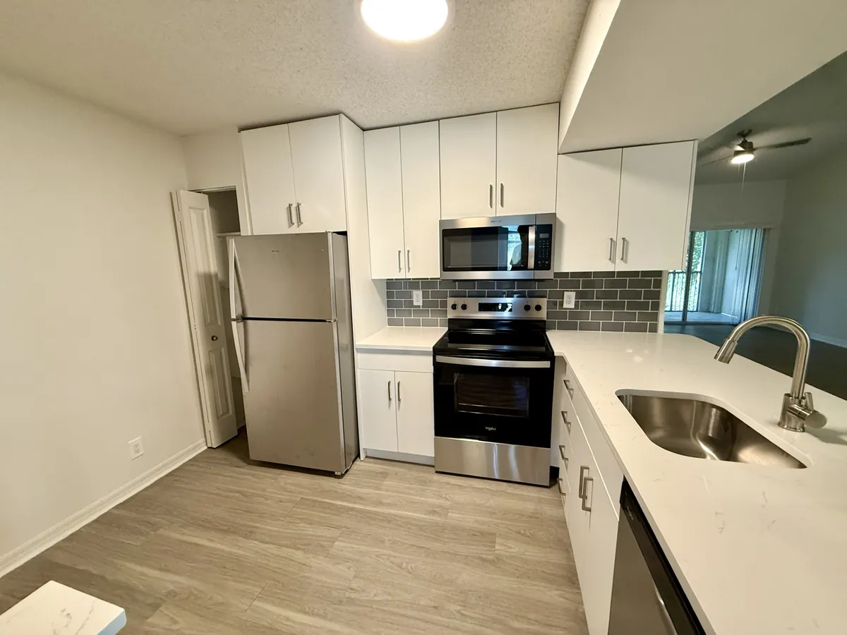 Modern white kitchen remodel by Patagonia Construction in Miami