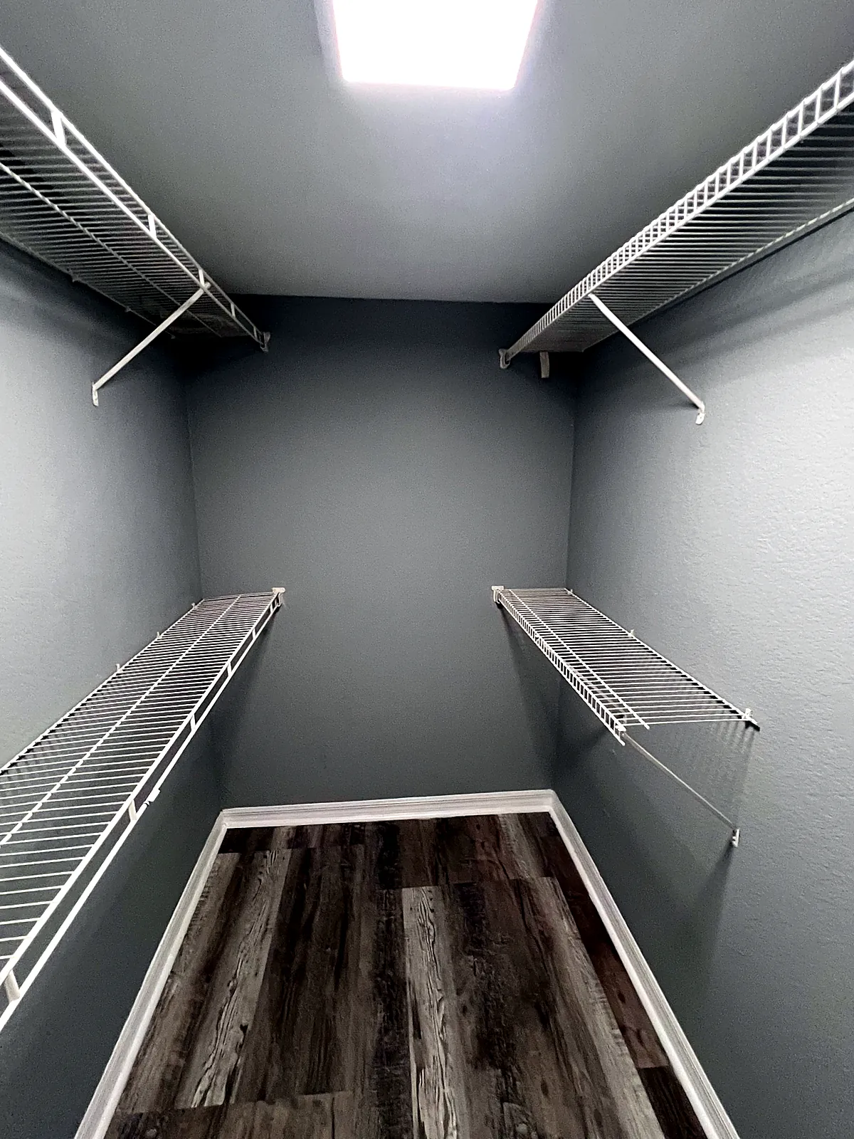 Walk-in closet repainted with clean trim lines and shelving reinstalled in Miami